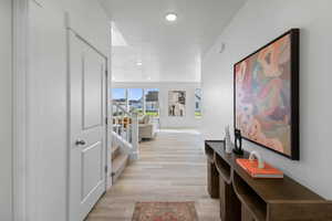 Hall with light hardwood / wood-style floors