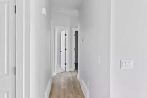 Hallway featuring light wood-type flooring