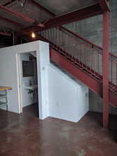 Stairs with sink and concrete floors