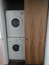 Laundry room featuring stacked washer and dryer