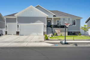 Craftsman inspired home featuring a garage and a front yard