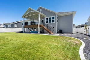 Back of house with a lawn and central AC unit