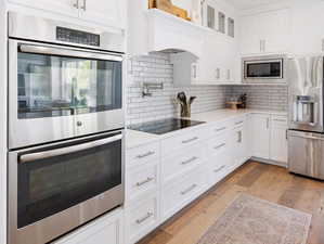 Every kitchen feature! Double oven, subway tile, induction stove and pot filler, stainless steel, new dishwasher.