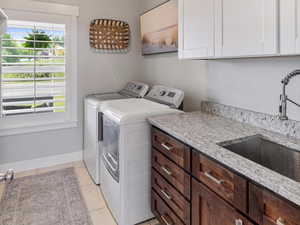 Granite and Sink and added Cabinets in the oversized laundry area off garage.