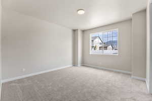 Carpeted spare room featuring a textured ceiling