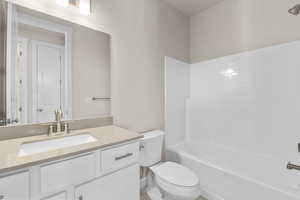 Full bathroom with shower / bathing tub combination, vanity, and toilet