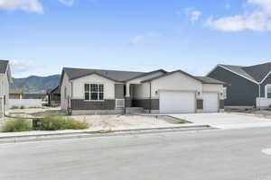 View of front of house with a mountain view and a garage