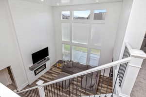 Living room featuring a high ceiling and hardwood / wood-style floors