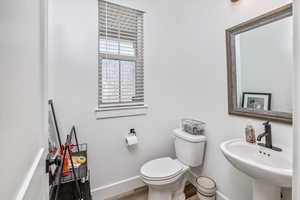 Bathroom featuring sink, hardwood / wood-style flooring, and toilet