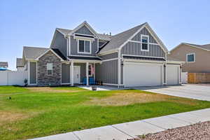 View of front of home featuring a garage and a front lawn