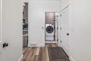 Washroom with washer / clothes dryer and wood-type flooring