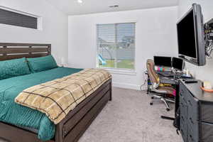 Bedroom featuring light colored carpet