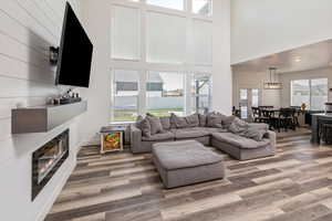 Living room featuring a high ceiling and wood-type flooring