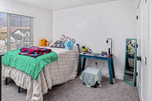 Bedroom with carpet floors and multiple windows