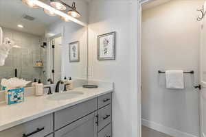 Bathroom with an enclosed shower and vanity