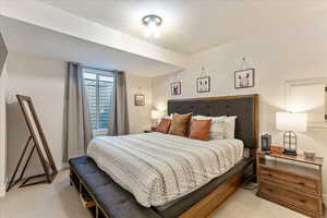 Bedroom featuring light colored carpet