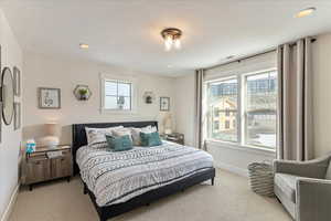 Bedroom with carpet and multiple windows