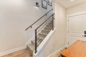 Stairway featuring wood-type flooring