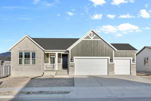 View of front of house featuring a garage and a porch