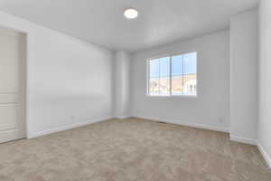 Spare room featuring light colored carpet