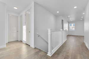 Corridor with light hardwood / wood-style floors