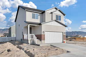 View of front of home with a garage and a mountain view