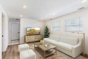 Living room featuring light wood-type flooring. Virtual Staging