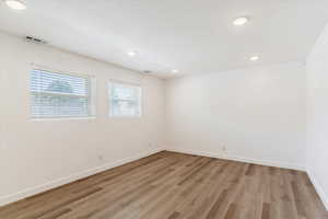 Unfurnished room with light hardwood / wood-style flooring