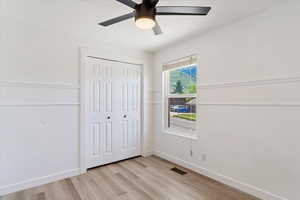 Unfurnished bedroom with light hardwood / wood-style flooring, a closet, and ceiling fan