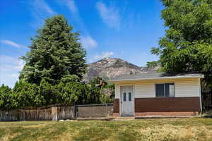 View of front of home featuring a mountain view and a front lawn