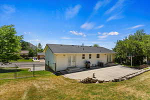 Back of house featuring cooling unit, french doors, a yard, and a patio area