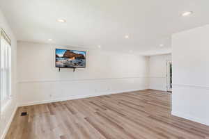 Unfurnished room featuring light wood-type flooring and a wealth of natural light