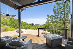 Deck with an outdoor living space with a fire pit