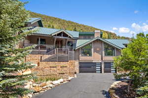 View of front of property featuring a garage and covered porch