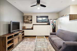 Living room featuring ceiling fan and hardwood / wood-style floors