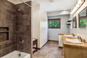 Bathroom with vanity and tiled shower / bath