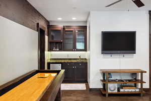 Bar featuring dark brown cabinets and ceiling fan