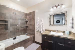 Full bathroom with vanity, toilet, and tiled shower / bath