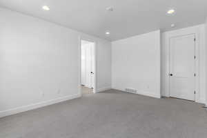 Unfurnished room with light carpet