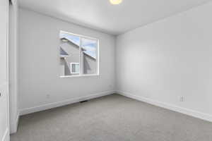 Empty room featuring carpet flooring