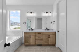 Bathroom featuring vanity and independent shower and bath