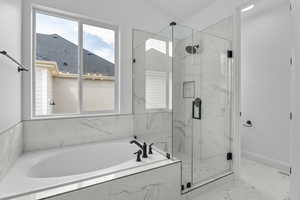 Bathroom featuring separate shower and tub