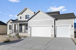 View of front of property with a garage and covered porch