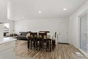 Dining area with light hardwood / wood-style floors