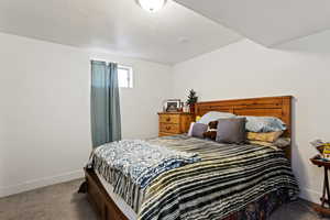 Carpeted bedroom with a textured ceiling