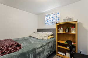 Bedroom with carpet and a textured ceiling