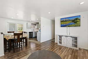 Dining area with sink and dark hardwood / wood-style floors