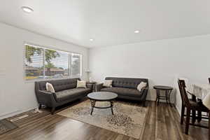 Living room with dark wood-type flooring