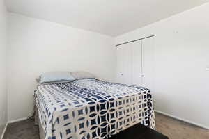 Carpeted bedroom featuring a closet