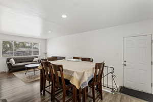 Dining space with hardwood / wood-style flooring